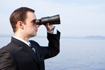 Fototapeta na wymiar Caucasian businessman with binoculars