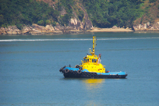 tug boat navigating a beautiful blue ocean