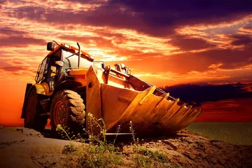 Papier Peint photo Tracteur Yellow tractor on golden surise sky