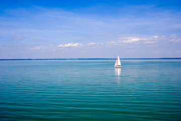 Blue landscape with sailboat