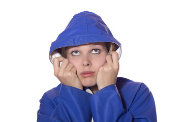 women in blue rain coat looking pessimistic