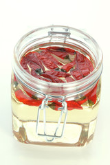 organic red chili in a jar with oil
