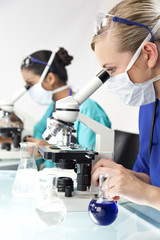 Fototapeta premium Female Scientific Research Team Using Microscopes in a Laborator