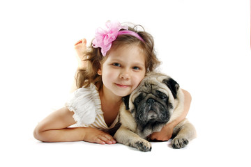 little girl 5 years with dog breed pug on a white background