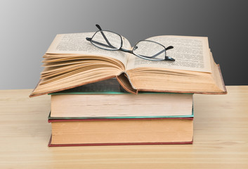 Eyeglasses on open book