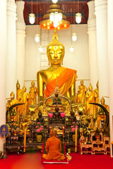 Monk meditating in church, Thailand