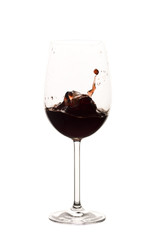 Red wine splashing in glass