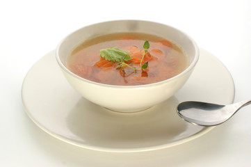 carrot soup with fresh organic herbs in a bowl