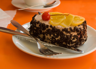 Chocolate сake with a cherry and pineapple