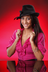 Cute teen with black hat on red