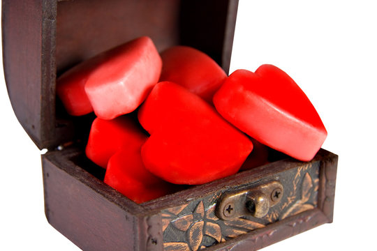 Open ancient treasury chest full of red hearts © Kirill Kurashov