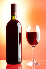 Glass and bottle of red wine.
