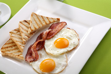 Breakfast - toasts, eggs, bacon