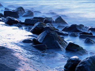 misty rocks along the coast at twilight - Powered by Adobe