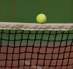 Tennis ball going over the net during a tennis match