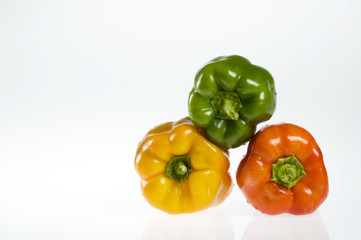 Three bell peppers on white