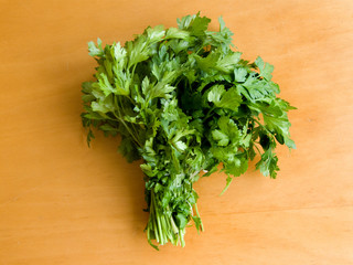 Fresh curly parsley on the wooden table. Up view.