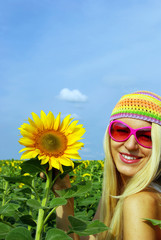 Pretty girl in glasses with a sunflower