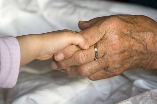 hand of grandmother and grandchild