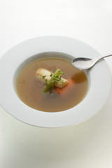 healthy soup with organic vegetables and a spoon