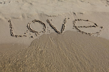 love inscription in sand