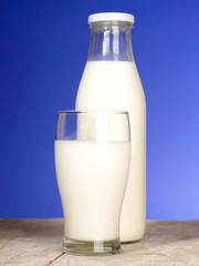 Bottle with fresh milk and glass on the table