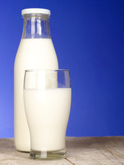 Bottle with fresh milk and glass on the table