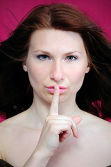 Fototapeta premium The girl with a finger near a mouth