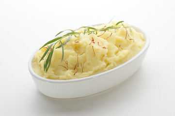 mashed potato with tarragon in a white bowl