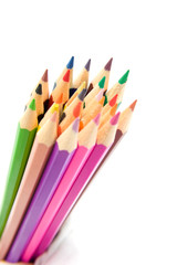 colored pencils in closeup over white background