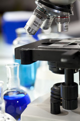 Microscope in a Scientific Research Laboratory With Flasks
