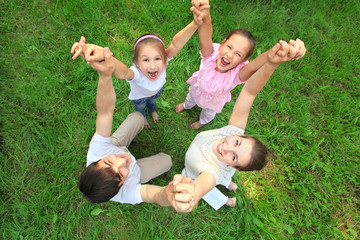 Parents with children stand having joined hands and having lifte