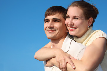 woman embraces  man from behind