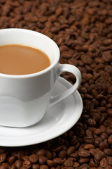 Cup with coffee, costing on coffee grain