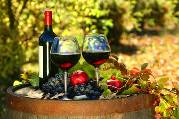 Glasses of red wine on old barrel - 16336721