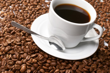 Cup with coffee, costing on coffee grain