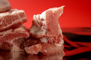 Pig, pork raw meat pieces over red