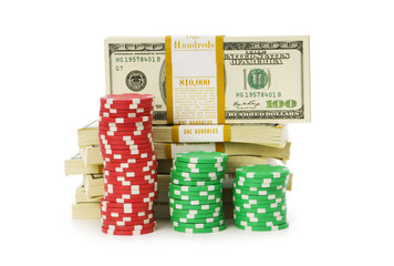 Dollar and casino chip stacks on white