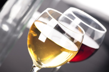 Two glasses of white and red whine. Grey background