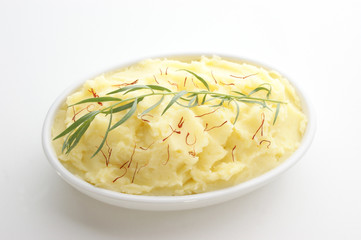mashed potato with tarragon in a white bowl