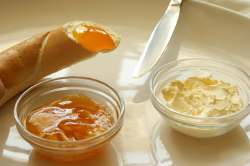bread roll and croissant with yellow plum jam