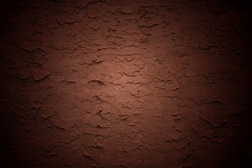 red stucco wall background with heavy vignette