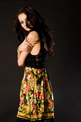 Girl in transparent clothing over dark background