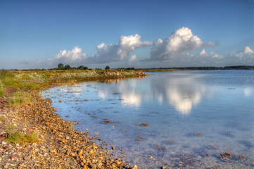 Fototapeta premium A seascape with beautiful clear water and blue sky