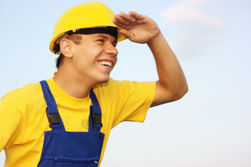 Worker looking forward, covering eyes from the sun