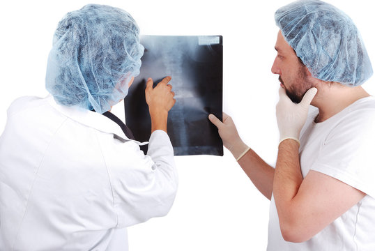 Two male doctors looking at scan image