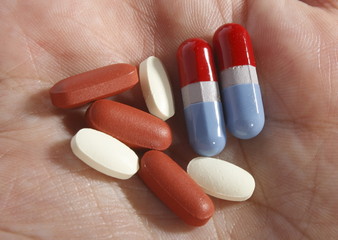 assorted medicine in palm