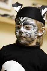 The boy makes a children's make-up