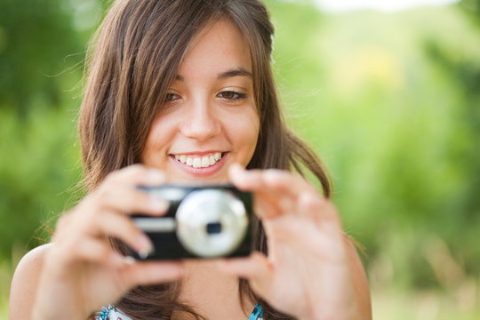 Young lady taking photos outdoors