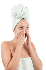 Young woman applying cream on her face